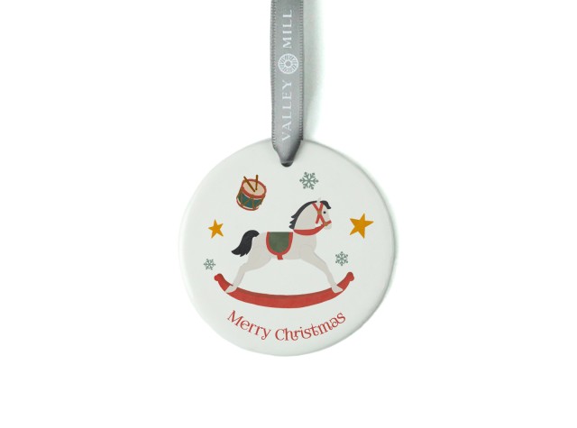White ceramic christmas tree decoration with the image of a cute rocking horse